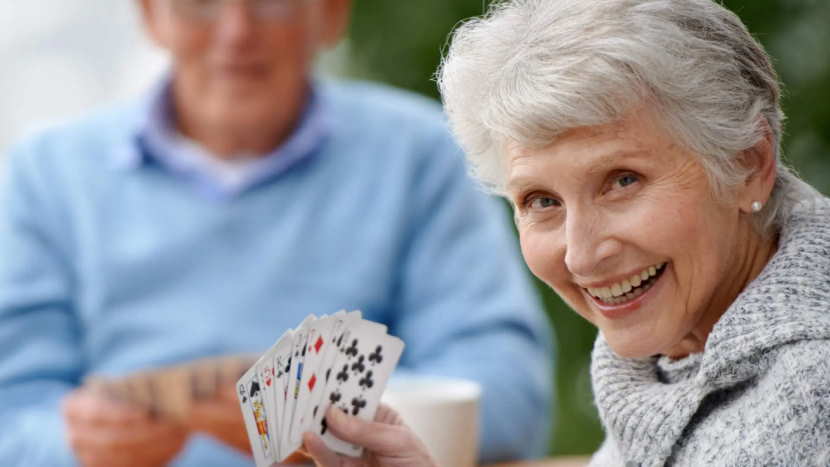 happy senior woman playing solitaire