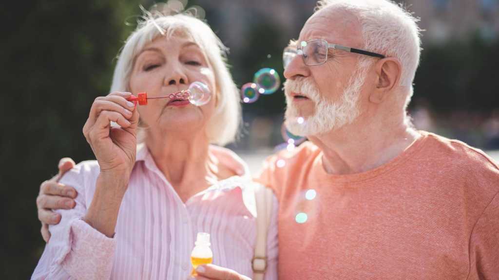 senior couple blowing bubbles