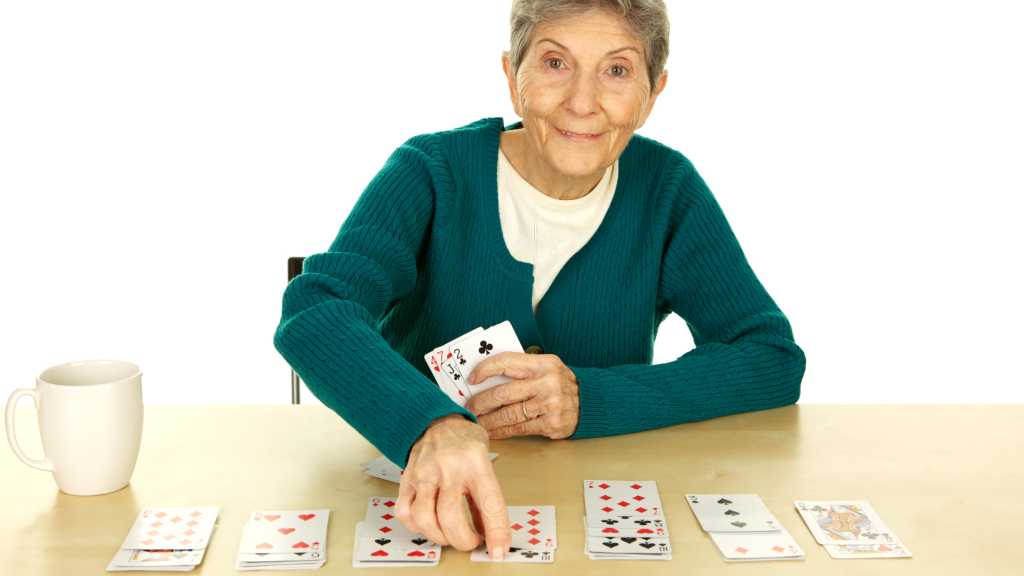 senior playing solitaire